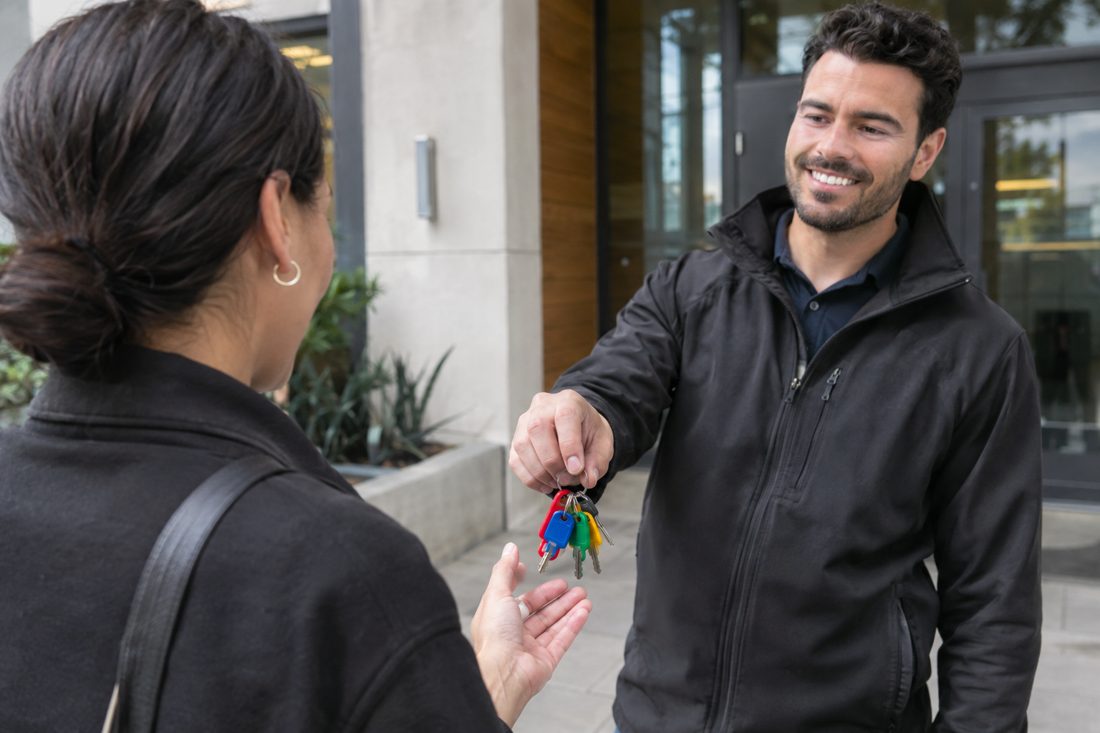 A ring of new color-coded keys handed over at a condo lobby at a modern Culver City condo building entry in Culver City, CA