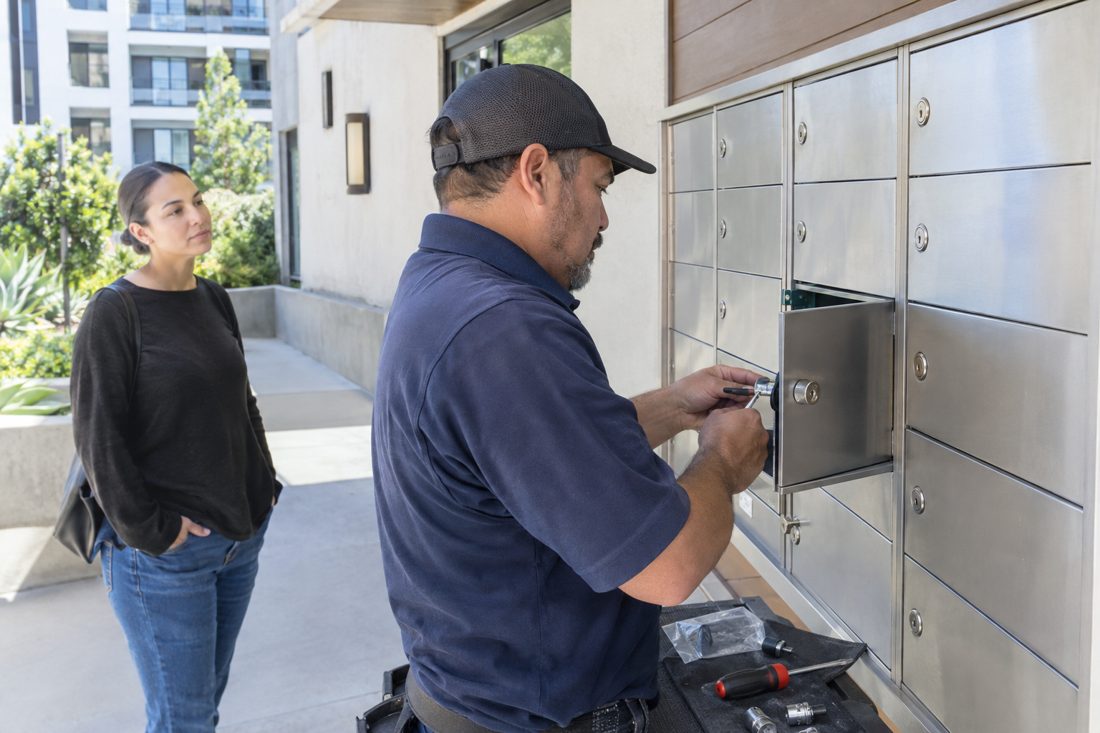 A mailbox lock being replaced at an apartment mailbox bank at a modern Culver City condo building entry in Culver City, CA